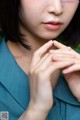 A close up of a woman with her hands clasped together.