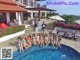 A group of women in bikinis posing by a swimming pool.