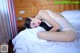 A woman laying on a bed in a white lingerie.