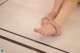 A woman's bare feet on a tiled floor. 